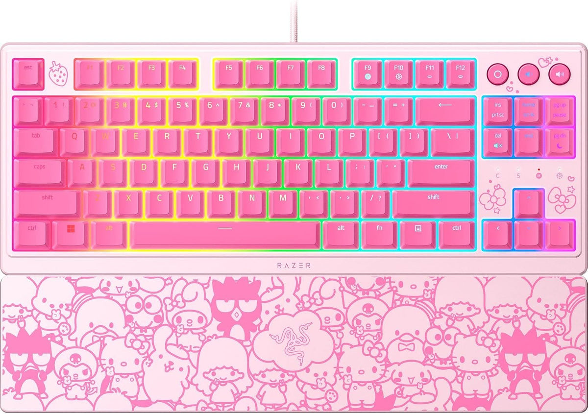 A Razer keyboard with pink keycaps and multicolor RGB backlighting, featuring a matching pink wrist rest covered in cartoon character line art, shown on a white background.